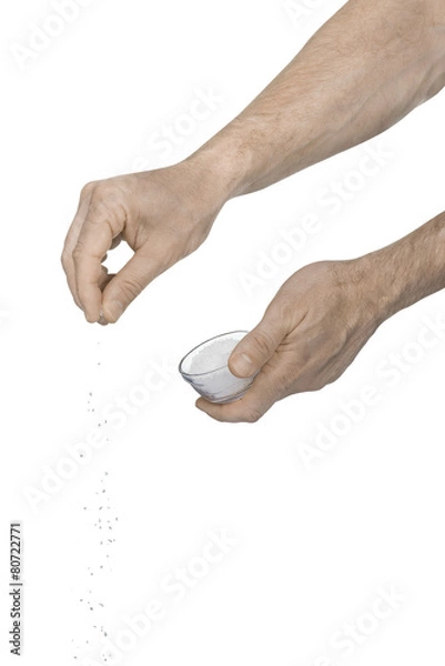 Obraz Tw male hands adding crushed salt on a white background