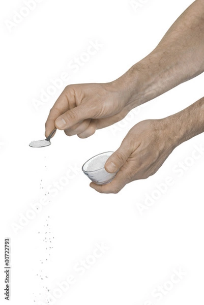 Obraz Two male hands adding crushed salt using a teaspoon