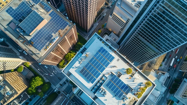 Obraz Aerial view of city with solar panels on rooftops of buildings. City skyline. Concept of sustainability and ecology.