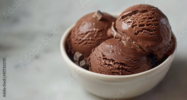 Obraz Chocolate Ice Cream Drizzled with Chocolate Sauce and Sprinkled with Chocolate Pieces, Served in a Modern Bowl