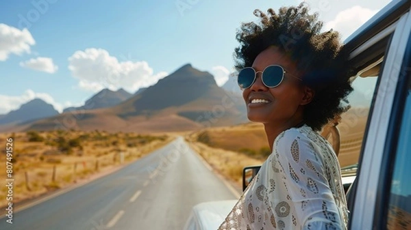 Fototapeta Woman on the road from car window, enjoying desert view and traveling in summer vacation and explore the freedom of nature in the sun