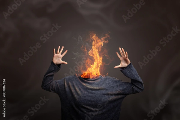 Fototapeta Head burning in flames showing burnout syndrome or mental illness.