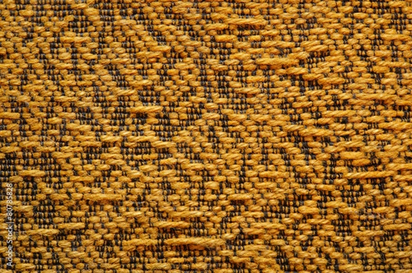 Fototapeta Woolen upholstery with orange color with a pattern of black thre
