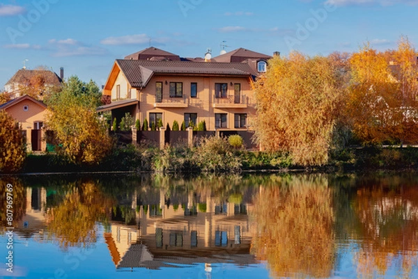 Obraz Lakeside homes. Rural area. Golden autumn. The conception of living by the lake.