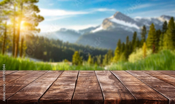 Obraz table background of free space for your decoration and blurred landscape of mountains.Blue sky with sun light and green small leaves.