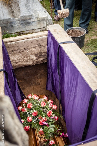 Obraz Mourners staying by the opened grave, burrying at a cemetery