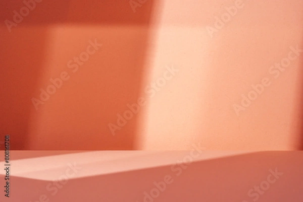 Obraz Empty table on salmon color background with natural shadow on the wall. Mock up for food, branding products, presentation, perfumes or health care..
