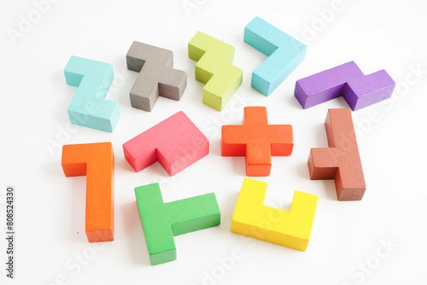 Fototapeta Logical thinking and problem solving problem solution creative business concept, wooden puzzle geometric block shape.