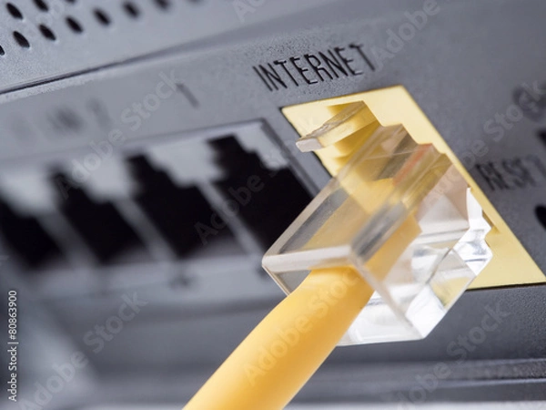 Fototapeta Network yellow cable connected to a router or modem