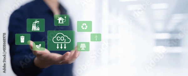 Fototapeta Businessman hand hold recycle symbol connection with virtual modern reduce CO2 emission concept with icons, global warming emissions carbon footprint climate change to limit global warming, energy