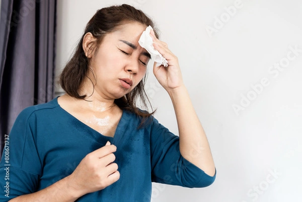 Obraz asian woman suffering from hot weather feeling tired and vertigo because of heat wave in summer