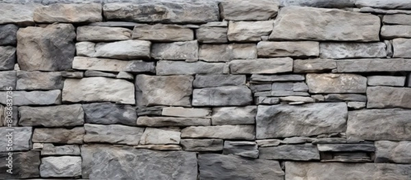 Fototapeta A portion of the wall that serves as a stone masonry giving texture and serving as a background for a copy space image