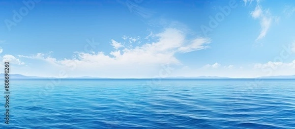 Fototapeta The gorgeous scenery features a captivating combination of a clear blue sky and an endless expanse of blue sea Copy space image