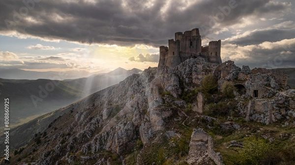 Obraz Rocca Calascio at sunset with warm light and clouds