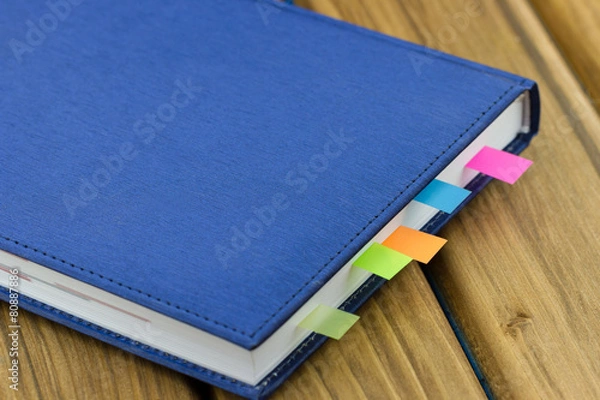 Obraz Close-up view of business diary with a colored bookmarks