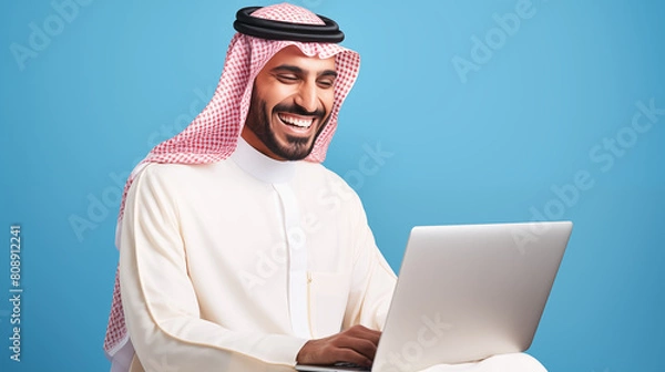 Obraz arab saudi smiling and happy man using laptop