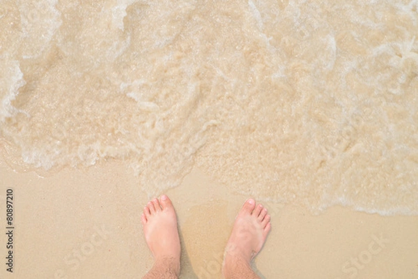 Obraz man legs on sandy beach