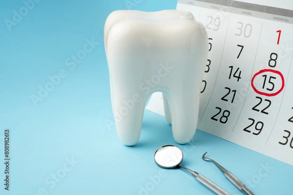 Fototapeta Dentist appointment calendar on a blue background with copy space