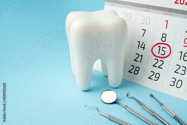 Fototapeta Dentist appointment calendar on a blue background with copy space