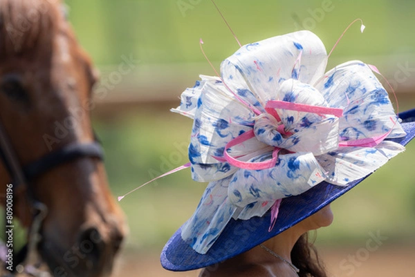 Obraz A women's fashionable hat is worn at a horse race