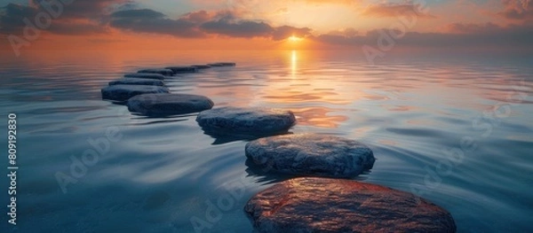 Fototapeta Sunset over a Calm Lake with Stepping Stones