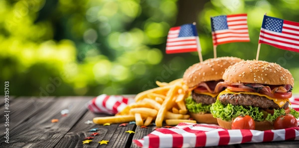 Fototapeta An American Independence Day celebration with a classic burger and fries on a picnic table adorned with the U.S. flag.
