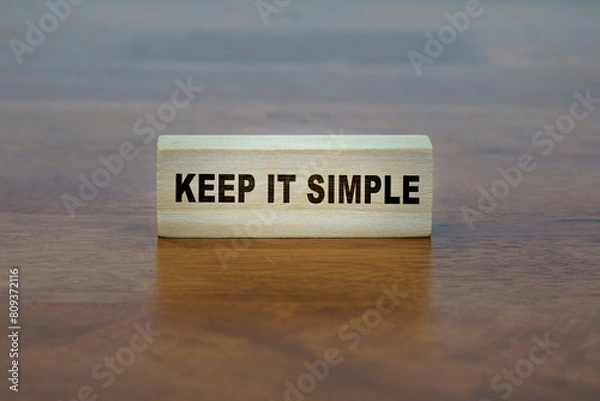 Fototapeta KEEP IT SIMPLE word on a wooden block.