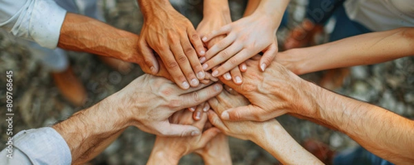 Fototapeta A group of people are holding hands in a circle. Concept of unity and togetherness