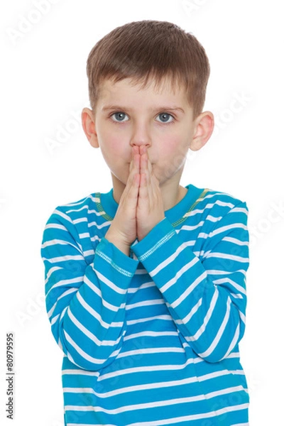 Obraz Serious boy holding hands in the face.