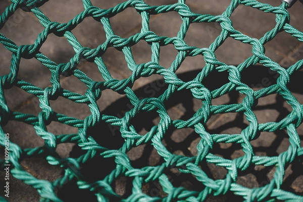 Fototapeta A net of green ropes