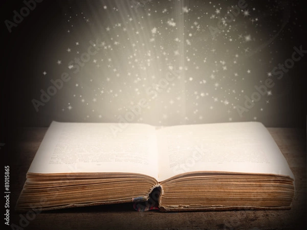 Obraz Old open book with magic light and falling stars