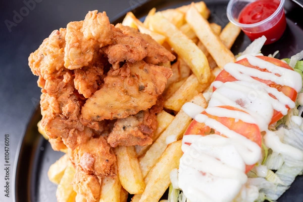 Obraz Deep-Fried Chicken chicharr n de pollo , Fried chicken nuggets, French fries and vegetables with chili sauce.