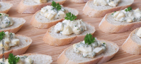 Fototapeta Egg salad served on slices of a baguette