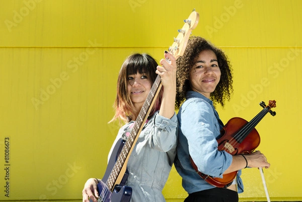 Obraz Women musicians standing back to back with instruments