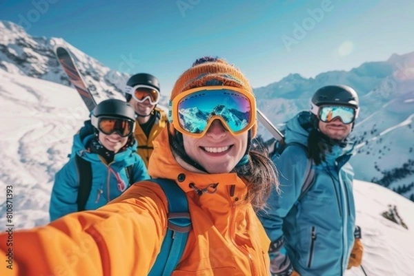 Fototapeta A group of people are smiling and posing for a picture on a snowy mountain. They are all wearing ski gear and backpacks