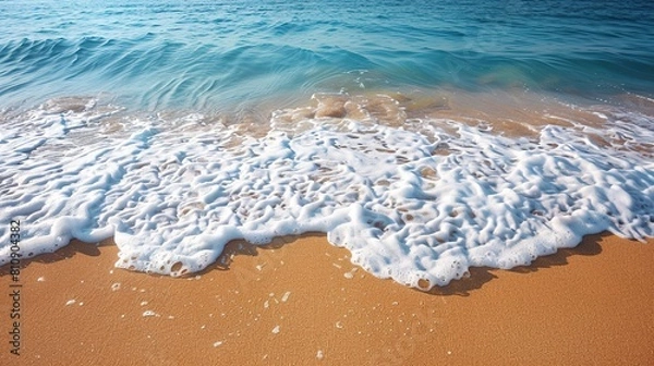 Fototapeta A serene beach scene with soft sand and gentle surf.
