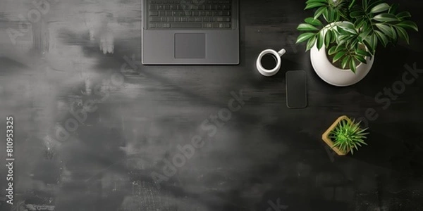 Fototapeta 黒いデスクの俯瞰視点、ノートパソコンと観葉植物、スマートフォン

