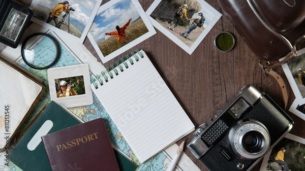 Fototapeta Couple photographs, travel photos, passports, old camera, map and notebook on a dark wooden table
