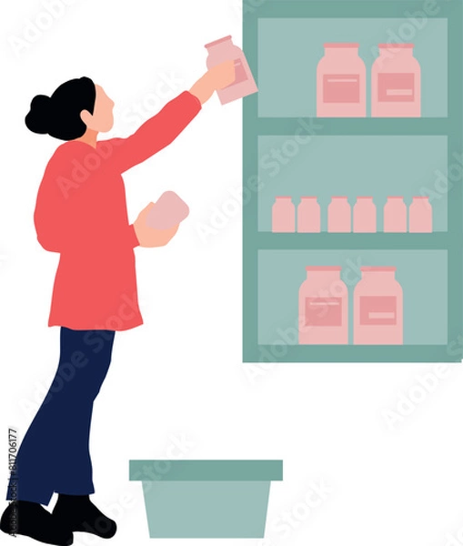 Fototapeta The girl is putting the bottles in the cabinet.