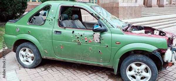 Obraz A car with traces of bullets and shrapnel
