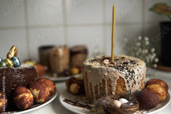 Fototapeta easter cake with chocolate and eggs on a white plate