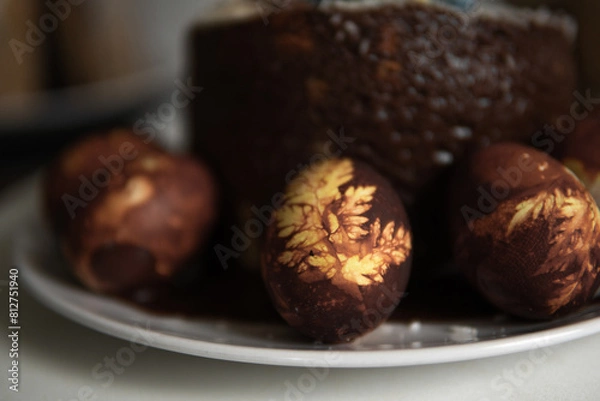 Fototapeta easter cake with chocolate and eggs on a white plate