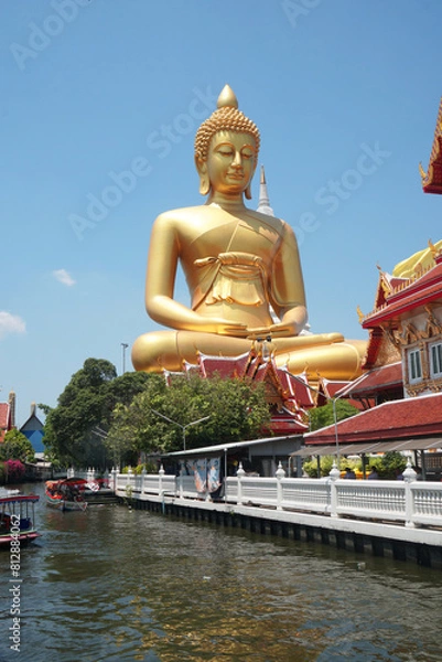 Obraz Big Golden Buddha Statue in Wat Pak Nam Phasi Charoen or Pak Nam Temple - It is famous for its large seated Buddha that is the largest in Bangkok Thailand - Travel Sculpture and Architecture Religion 