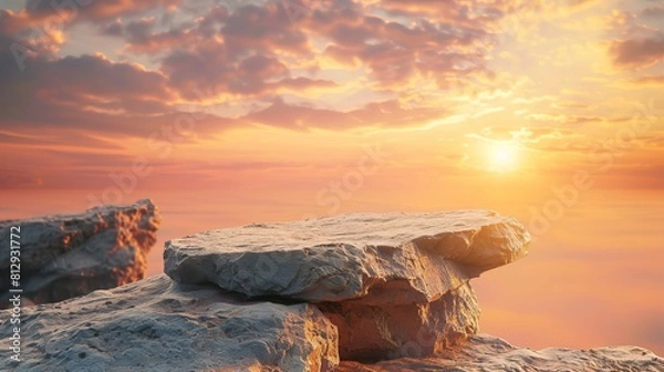 Fototapeta A rock stone podium against a sunset sky background is illustrated, featuring orange sunlight and ample space for displaying products in a banner background.