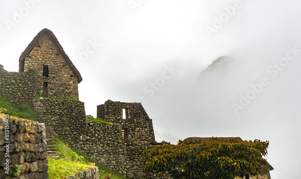 Fototapeta ancient town in machu picchu. Antique houses of the incas in a cloudy day and 