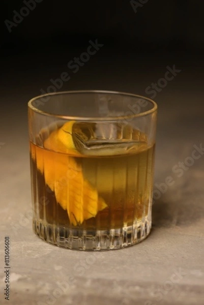 Fototapeta Vertical shot of a cocktail on a wooden background.