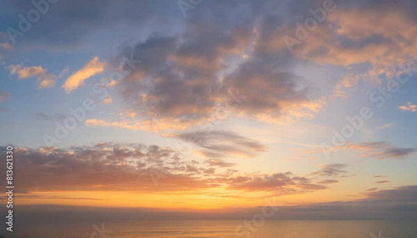Fototapeta Real majestic sunrise sundown sky background with gentle colorful clouds.