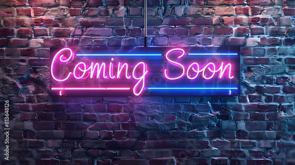 Fototapeta A striking neon sign with the words 'Coming Soon' set against a weathered brick wall, glowing in a vibrant pink and blue hue, invoking anticipation