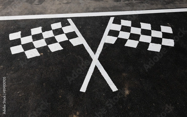 Obraz Checked flag at motorsport race track on road