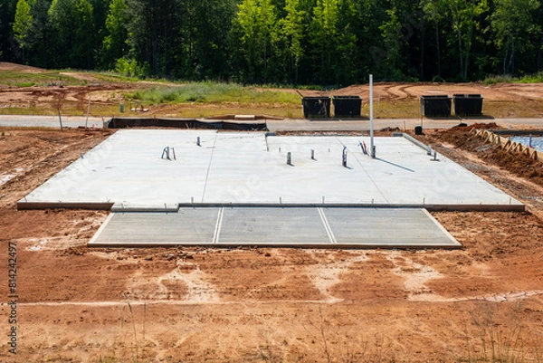 Fototapeta Slab-on-grade foundation with plumbing prep for residential house development
